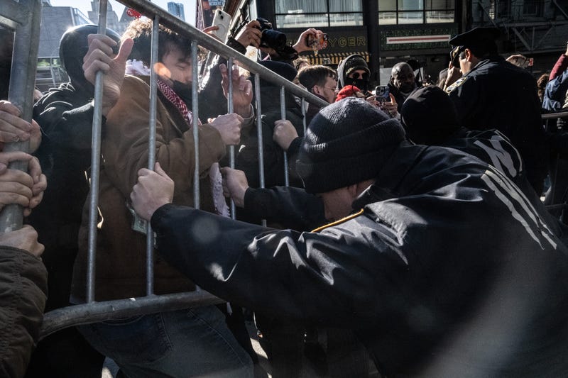 New York Police Department officers respond as demonstrators block a garage used by ICE vans during a protest against a purported ICE raid on Canal Street on Nov. 29