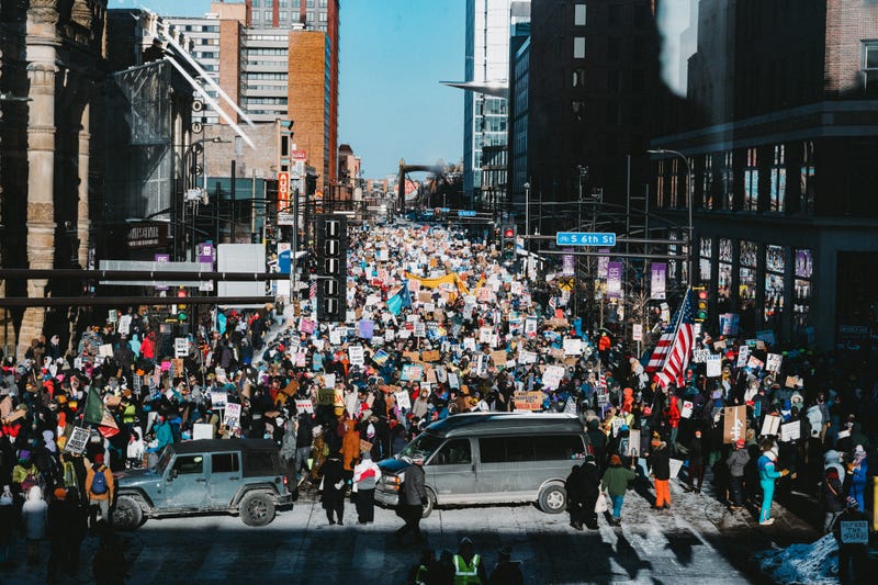 Demonstrators against the ongoing Immigration and Customs Enforcement (ICE) deployment march through downtown Minneapolis on Jan. 23. On Friday, demonstrators have called for a nationwide strike, asking Americans to skip school and work and avoid spending at businesses.
