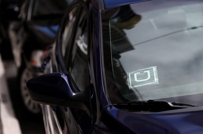 SAN FRANCISCO, CA - JUNE 12: A sticker with the Uber logo is displayed in the window of a car on June 12, 2014 in San Francisco, California. The California Public Utilities Commission is cracking down on ride sharing companies like Lyft, Uber and Sidecar 