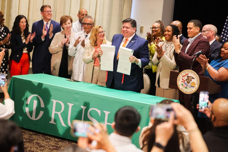 Illinois Gov. J.B. Pritzker poses for a photo after signing the Healthcare Protection Act into law. The measure is meant to block what he described as insurance companies' "predatory tactics to make an extra dime" by shortchanging consumers on their medical needs.