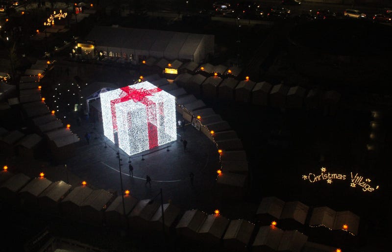 A 27-foot-tall Christmas present sits in the middle of the Christmas Village in LOVE Park.