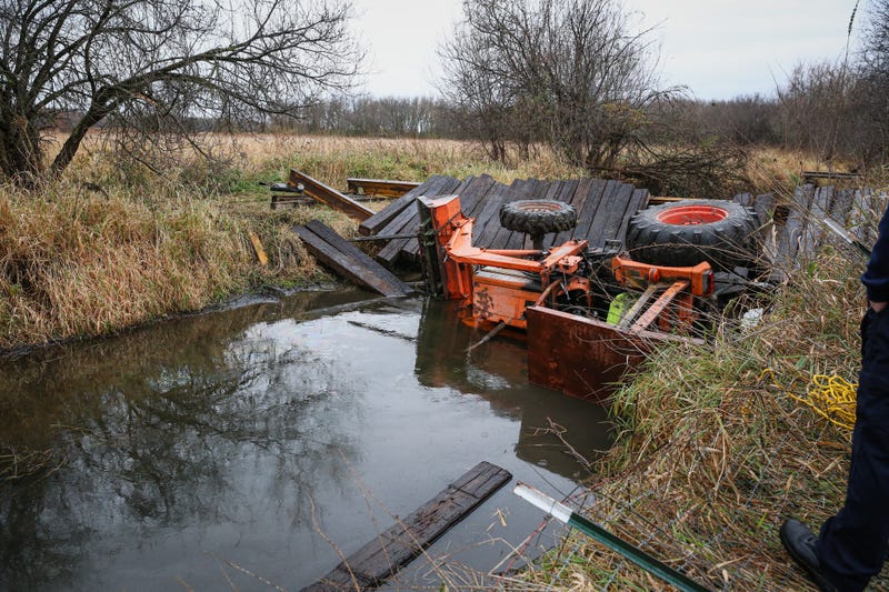 overturned tractor at Woodstock creek
