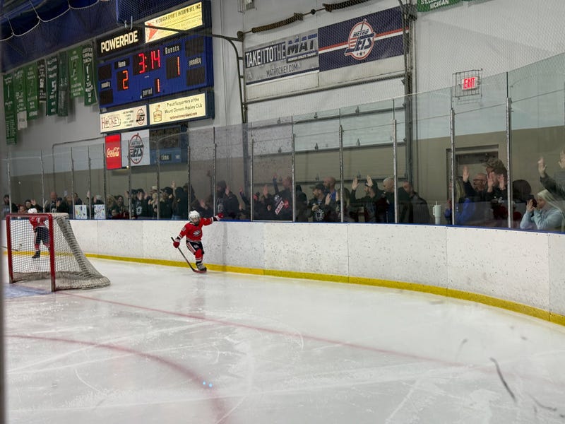 Young boy on ice playing hockey