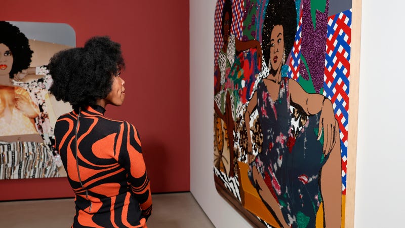 A guest browses Mickalene Thomas: All About Love at its debut at The Broad in Los Angeles.