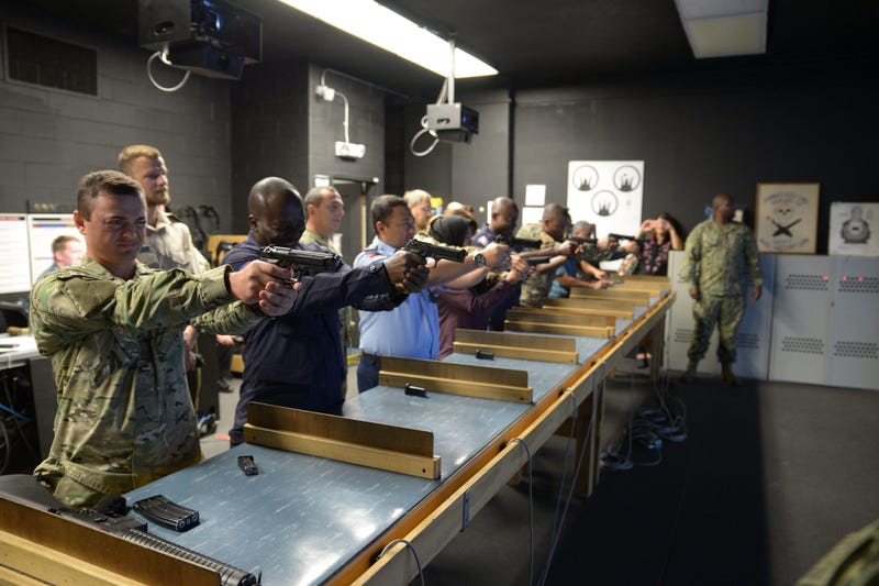 Training Security Assistance Field Activity Foreign Students try out the Gunner&apos;s Mate &apos;A&apos; School&apos;s Fire Arms Training Simulator