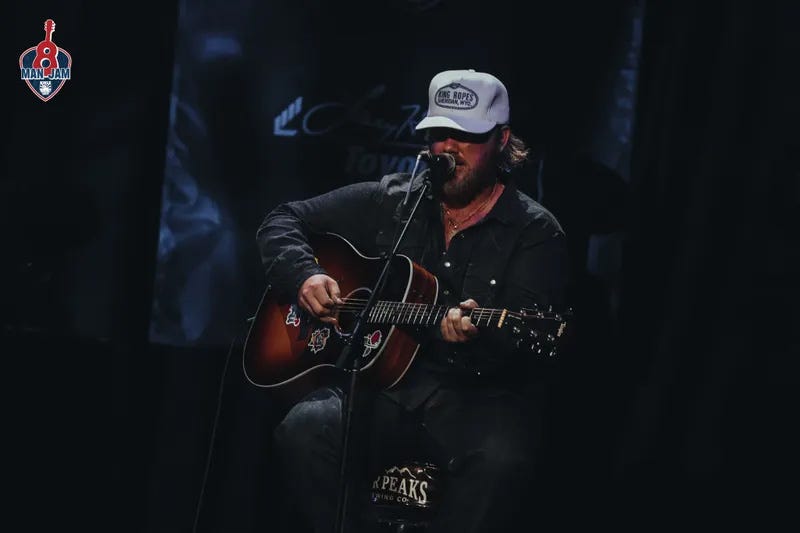 Country artist performing on stage.