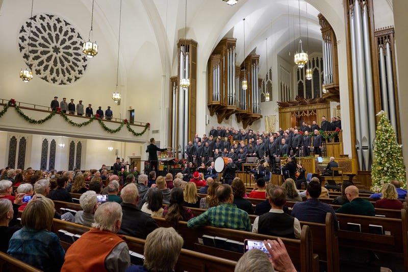 choir performs in front of large crowd in a beautiful sanctuary 