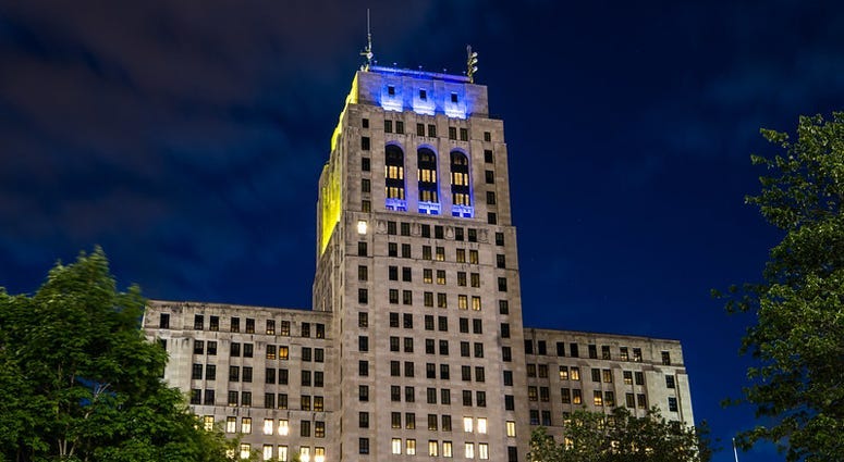 The Alfred E. Smith Building in Albany lit in blue and gold
