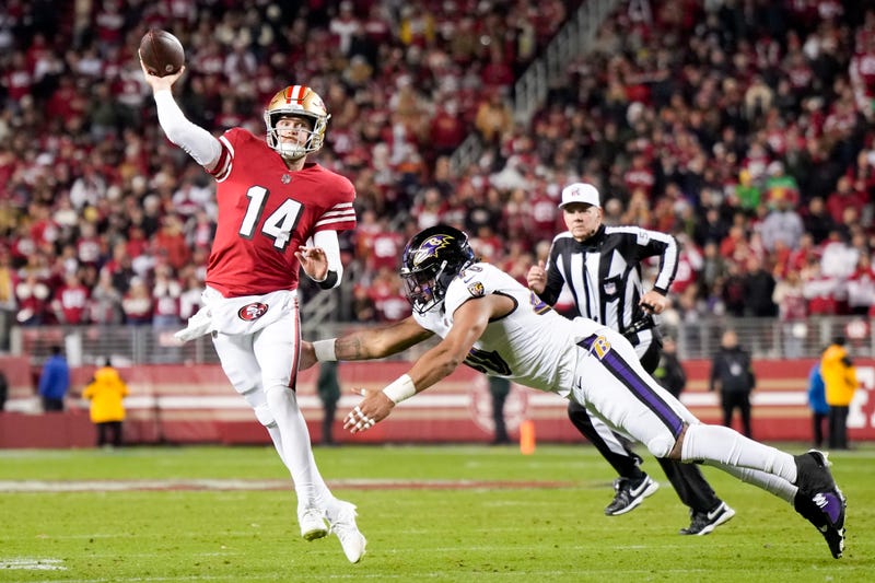 Malik Harrison #40 of the Baltimore Ravens attempts to tackle Sam Darnold #14 of the San Francisco 49ers as he attempts a pass during the fourth quarter at Levi's Stadium on December 25, 2023