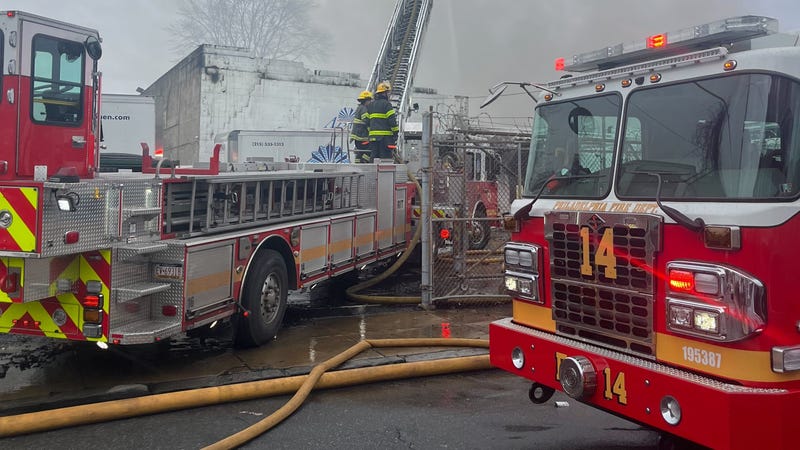 Firefighters work to extinguish a fire in the city's Frankford neighborhood.