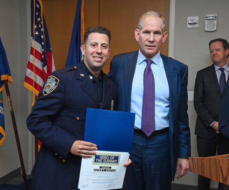 MTA CEO Janno Lieber presenting Detective Henry Greco with his certificate