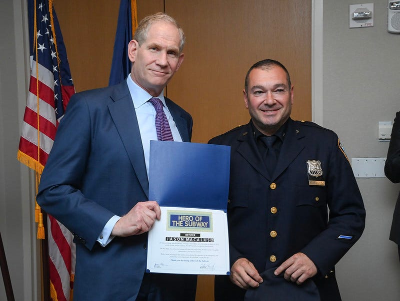 MTA CEO Janno Lieber presenting Officer Jason Macluso with his certificate