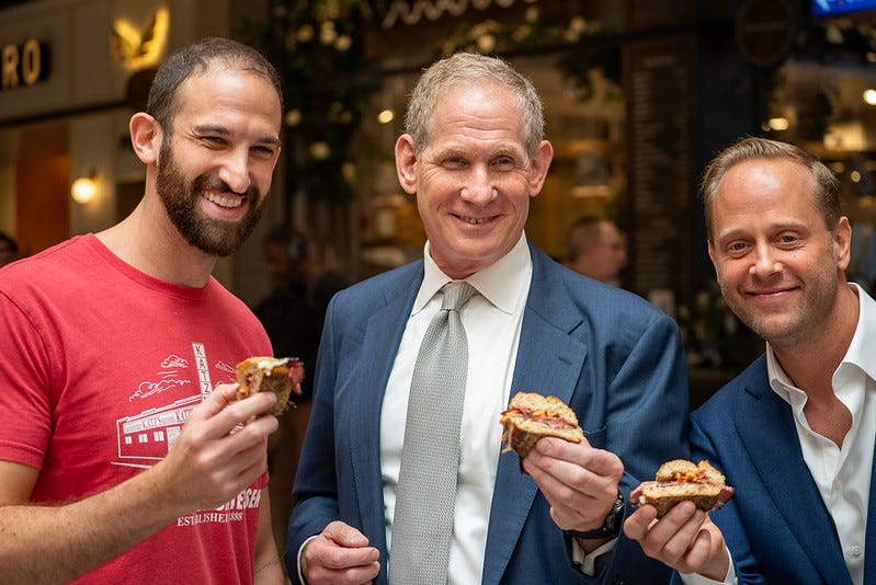 Jake Dell, Janno Lieber and Jon Streep holding 1904 sandwich