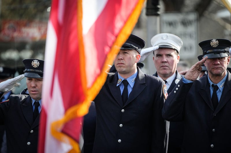 Firefighters salute at the funeral for FDNY Firefighter William P. Moon II at St. Patrick’s Roman Catholic Church in Bay Shore, New York, on Dec. 29, 2022