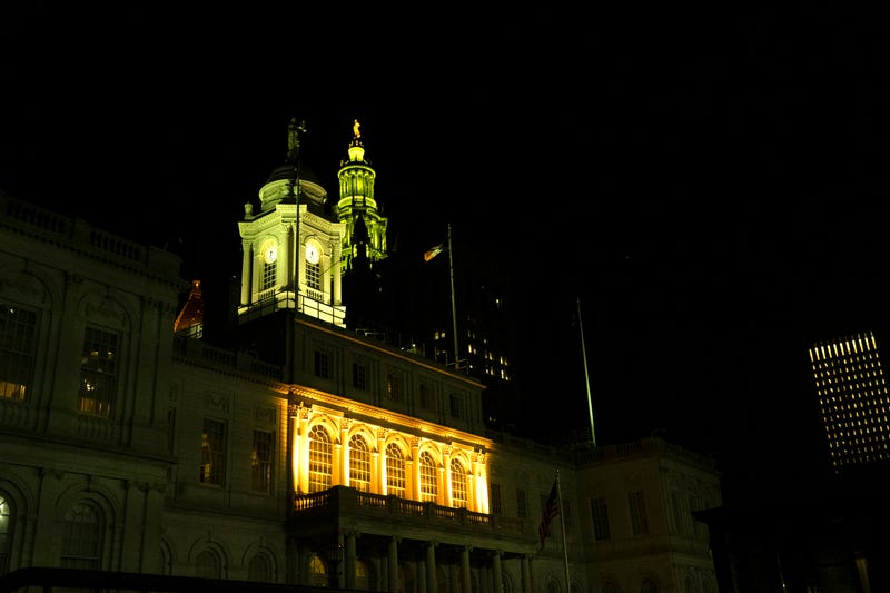 City Hall and the David N. Dinkins Manhattan Municipal Building are seen illuminated in yellow in honor of International Holocaust Remembrance Day on Jan. 27, 2023