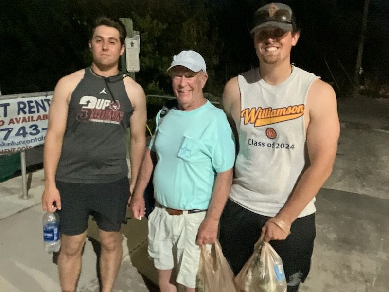 John Hunter (center) with two of his grandsons.