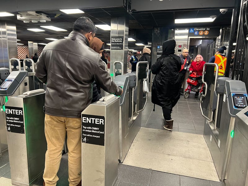 Riders use the new gates at the Sutphin Boulevard–Archer Avenue station in Jamaica on Monday