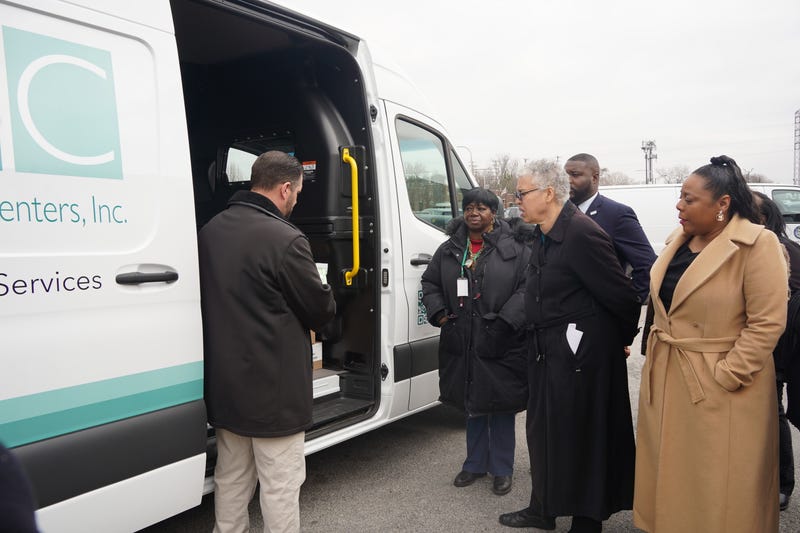 officials outside van