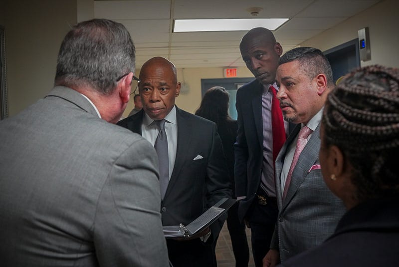 Mayor Eric Adams and NYPD Commissioner Edward Caban (right) are briefed at Jamaica Hospital Medical Center on Monday night