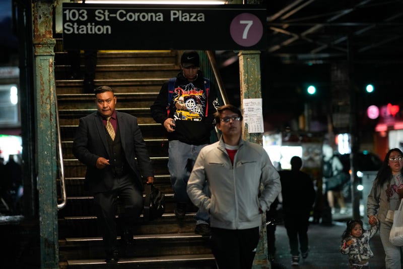 Residents walk from the 7 train as the mayor announced the operation on Oct. 15, 2024
