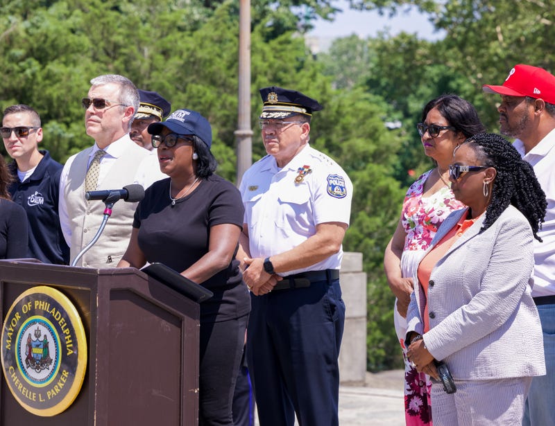 Mayor Cherelle Parker (podium), Police Commissioner Kevin Bethel (behind) and other city officials hold a press conference on July 3, 2025, assuring that Fourth of July celebrations will go on safely amid the city workers strike.