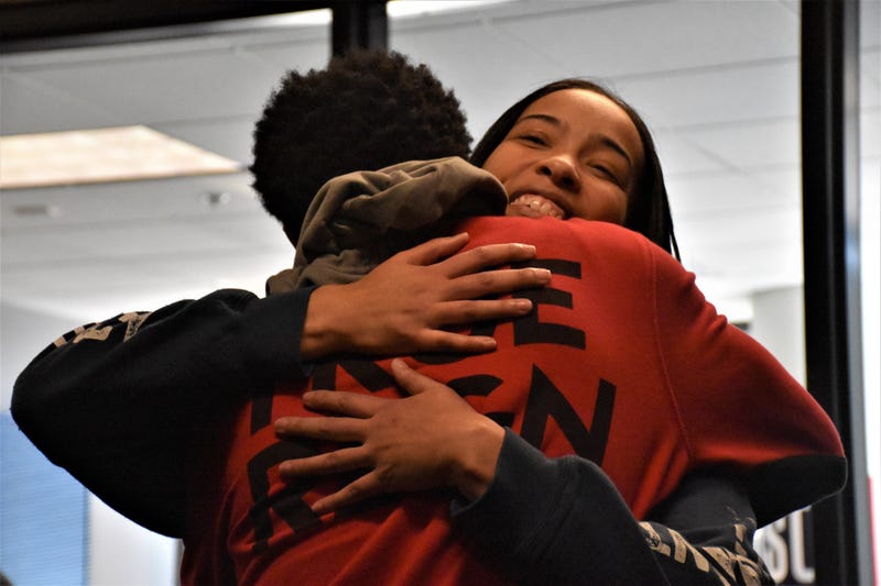 Marva Burns smiles, as she hugs her son Marquis Butts