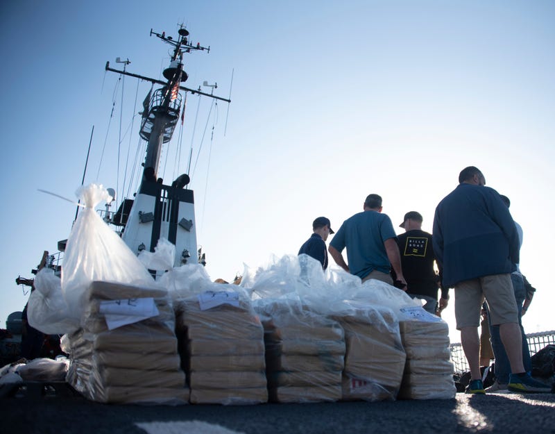 Coast Guardsmen prepare bails of cocaine to be offloaded