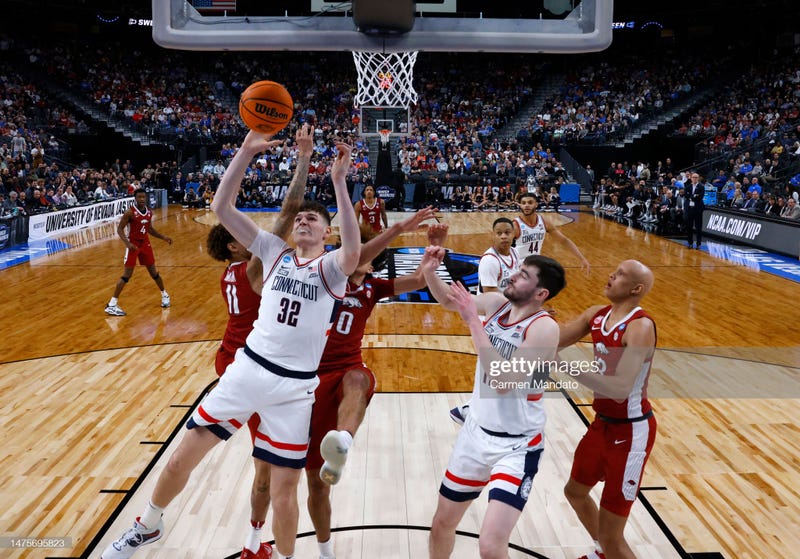 Donovan Clingan #32 of the Connecticut Huskies battles for a rebound during the second half against the Arkansas Razorbacks in the Sweet 16 round of the NCAA Men's Basketball Tournament at T-Mobile Arena on March 23, 2023 in Las Vegas, Nevada.