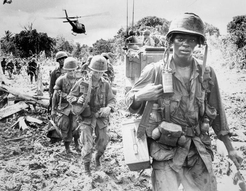 Men of the 173rd Airborne Brigade on a search and destroy patrol after receiving supplies, 1966. 