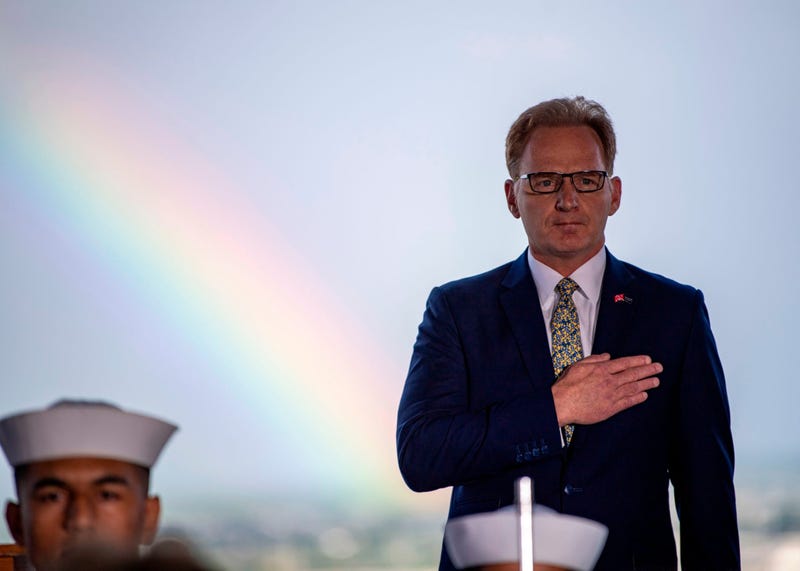 Acting Secretary of the Navy Thomas B. Modly, shows honors during the parading of the colors during the unveiling of the new Ford-class aircraft carrier USS Doris Miller (CVN 81)