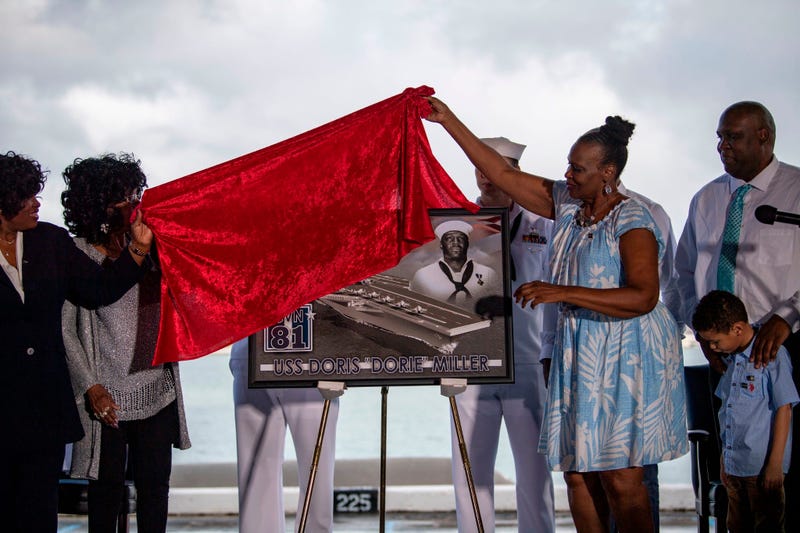 Family of late Ship's Cook 3rd Class Doris Miller unveil a plaque commemorating the future Navy ship, Ford-class aircraft carrier USS Doris Miller (CVN 81)