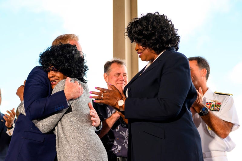 Brenda Haven, niece of World War II hero Doris “Dorie” Miller, hugs Acting Secretary of the Navy Thomas B. Modly after the unveiling of the new Ford-class aircraft carrier USS Doris Miller (CVN 81)