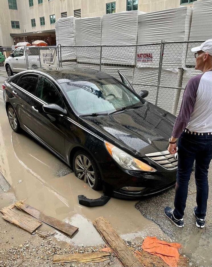 James Carville assessing the depth of a pothole