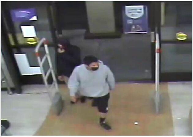 security video of two men walking into store