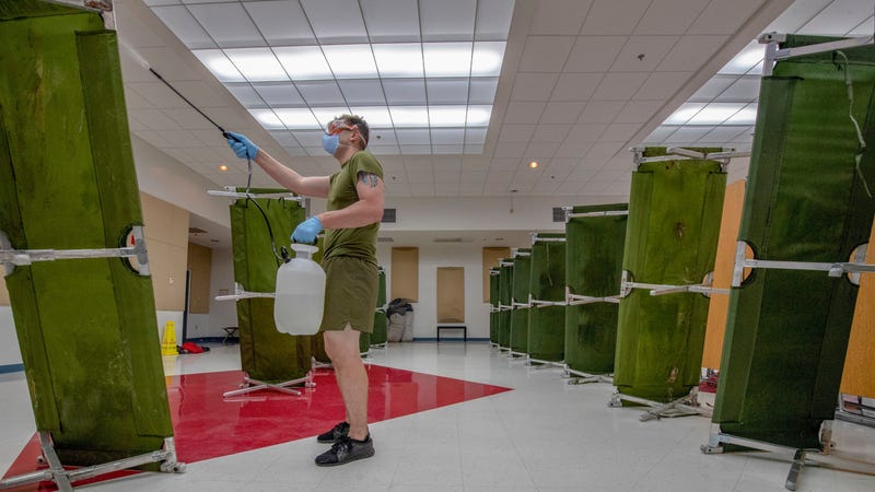 Hospital Corpsman sterilizes a building in support of USS Theodore Roosevelt