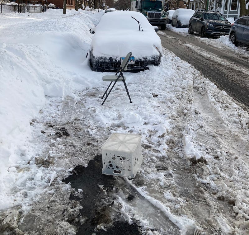 A milk crate and a folding chair hold a parking space in Chicago's Ravenswood neighborhood, February 2021. 