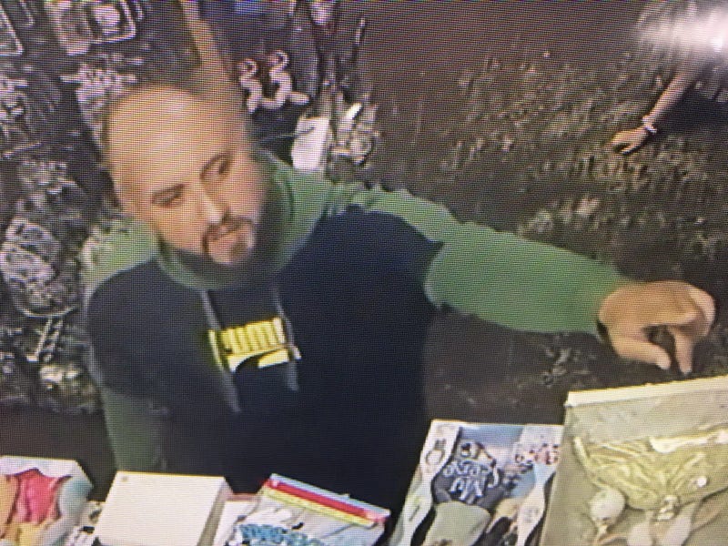 A Concord shopkeeper released surveillance images of two adults who allegedly distracted him while a child stole a Legos set.