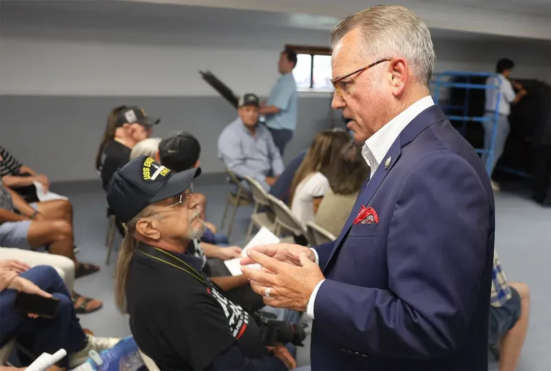 Rep. Mark Alford, right, introduces himself to Douglas Walther, left, before the town hall on Wednesday at the Lions Club in Harrisburg. An NPR tally reported that around 37 of the 219 U.S. House Republicans held town halls during the August recess.
