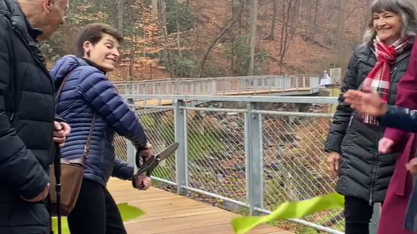 The ribbon is cut on Lida Way Bridge over the Valley Green Run streambank.