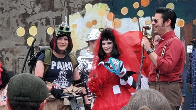 A pair of cosplayers dressed as a Ghostbuster (left) and Lydia Deetz from "Beetlejuice" enter the costume contest at Blobfest.