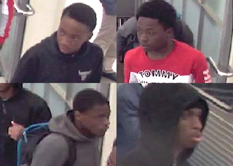 Police say four males are wanted for robbing people on the Red Line.