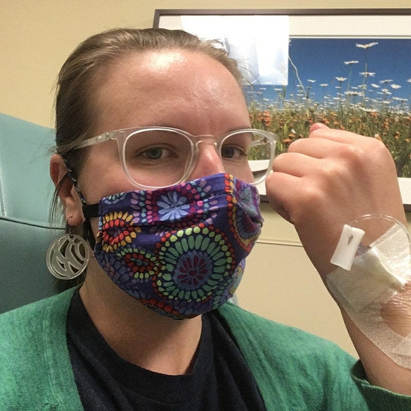 This May 2020 photo provided by Britta Bloomquist of Duluth, Minn., shows her with an infusion to treat a rare type of arthritis called ankylosing spondylitis. Bloomquist has been reading her clinical notes for years, first struggling through red tape and more recently clicking into a secure online patient website. “It means information about your care can no longer be hidden from you. And you have a say in your care,” she says.