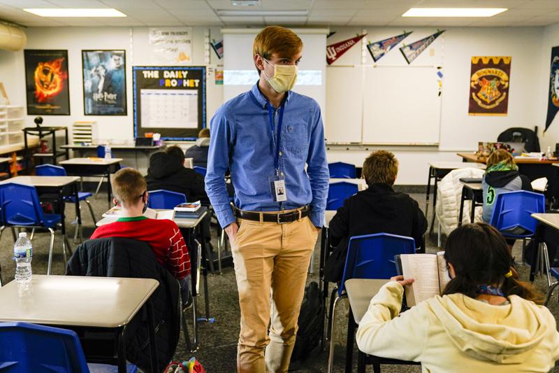 FILE - In this Dec. 10, 2020, file photo, Cooper Hanson, a substitute teacher at the Greenfield Intermediate School in Greenfield, Ind., is photographed in a classroom. Indiana schools reported more new COVID-19 cases during the last full week of August 2021 than at any previous time during the pandemic as the state continues to grapple with a surge in infections and hospitalizations.