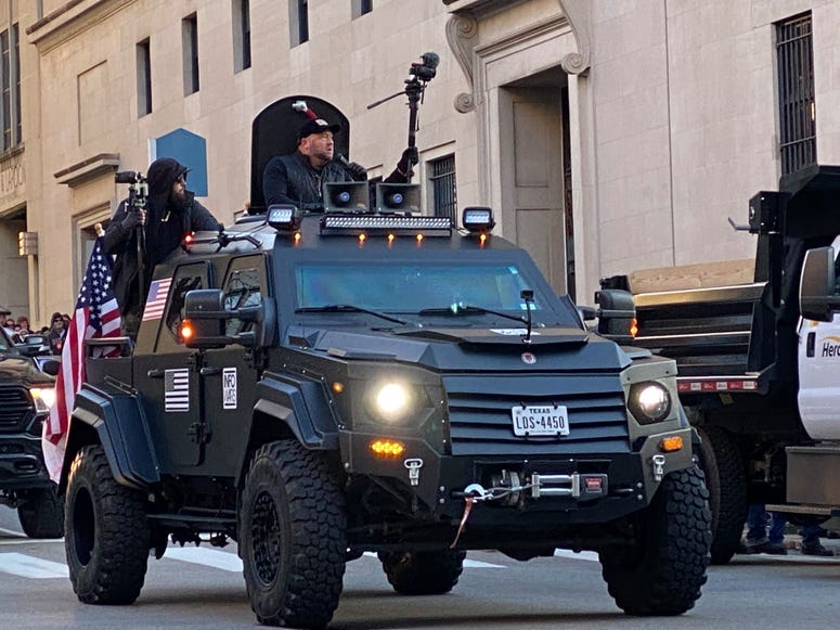 Conservative Talk Host Alex Jones rides through streets of Richmond in a military syle vehicle. (Jay Hart, WINA)