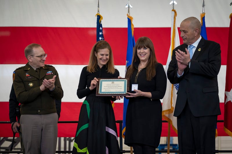 U.S. Army Maj. Gen. Francis Evon, adjutant general for the Connecticut National Guard, Connecticut Lt. Gov. Susan Bysiewicz, and U.S. Army Command Sgt. Maj. (ret.) John Carragher, the manager of veterans advocacy and assistance for the Connecticut Department of Veterans Affairs, present the Connecticut Wartime Service Medal to Renee DiNino, granddaughter of Tech. Sgt. Frank DiSalvo during a ceremony at Bradley Air National Guard Base, East Granby, Conn. Feb. 28, 2025