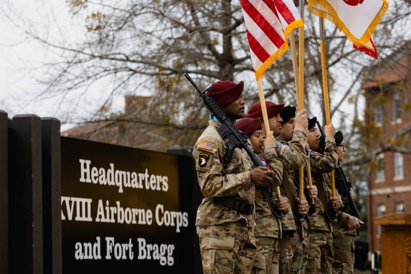 Members of the XVIII Airborne Corps color guard stand at attention during the base redesignation ceremony in front of the newly unveiled Headquarters XVIII Airborne Corps and Fort Bragg sign on Fort Bragg, N.C. March 7, 2025.
