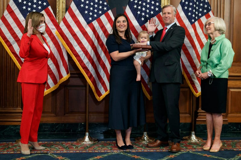 House Speaker Nancy Pelosi of Calif., left, standing at a distance due to coronavirus precautions, holds a ceremonial swearing-in for Congressman-elect Chris Jacobs, R-N.Y., Tuesday, July 21, 2020, on Capitol Hill in Washington