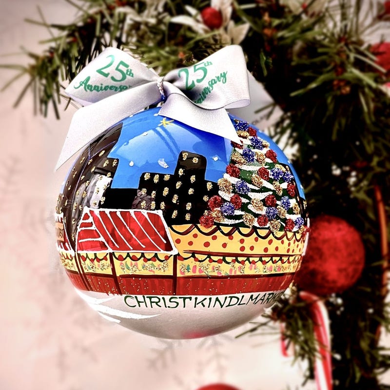 This year marks the release of the first annual Christkindlmarket ornament. The new high-quality souvenir is a specialty glass-blown, hand-painted ornament from Europe, complete with a scene of quaint red and white striped booths, and celebratory fireworks.