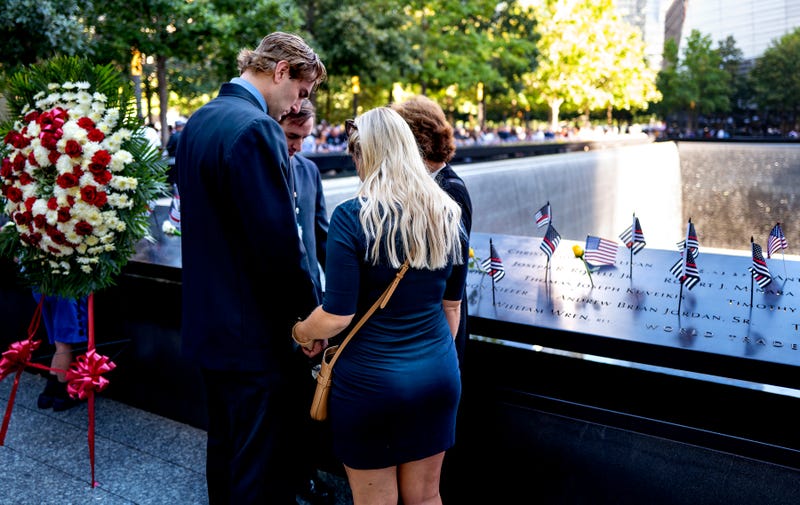 : People pause at 9:59 A.M., the moment 20 years ago the south tower of the World Trade Center fell, during a ceremony at the 9/11 Memorial and Museum on September 11, 2021 in New York City.