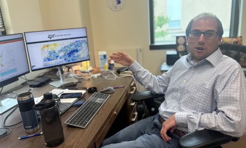 Missouri State Climatologist Zack Leasor examines weather reports to assess drought from his office in Columbia on May 29.